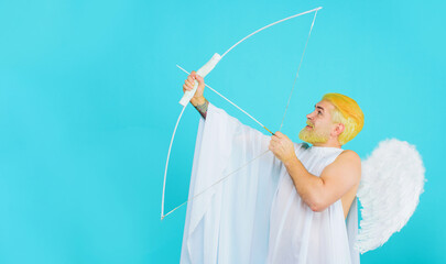 Valentines day angel with bow and arrows. Bearded man in angel costume aiming with bow. Symbol of...