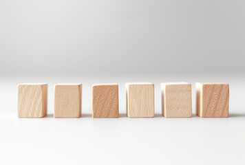 A set of wooden blocks in a row on a white surface, presented in the style of light orange and light beige, observational photography, use of earth tones, and functional aesthetics.