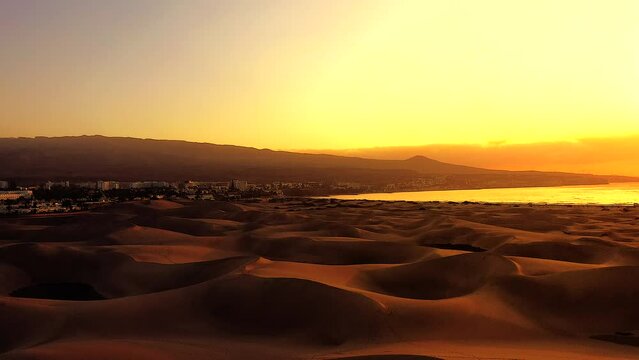 Sunset in the Dunes of Maspalomas with the City of Playa del Ingl&eacute;s in the background - Aerial View
