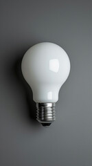 White Light Bulb Illuminating a Gray Wall