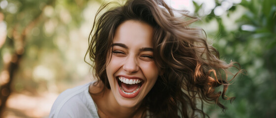 Captivating Laughter in Lush Greenery: Exuberant Young Woman Enjoying a Heartfelt Chuckle in Nature's Embrace