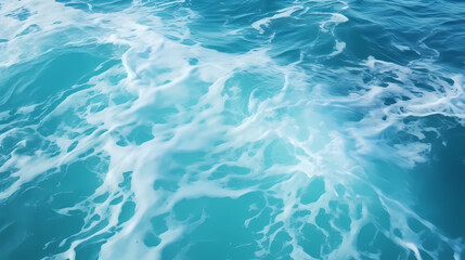 Obraz premium Sandy beach with light blue transparent water waves and sunlight, tranquil aerial beach scene