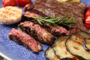 Delicious grilled beef with vegetables and rosemary on plate, closeup