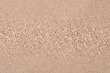 Texture of soft beige fabric as background, closeup