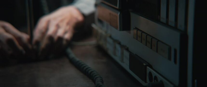 A man taking the phones from the stand and rewind the recording