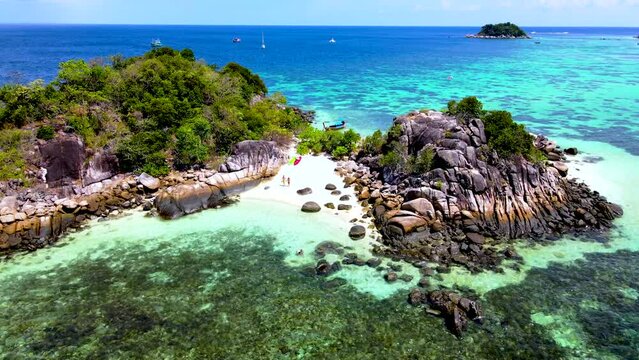 a couple of men and women at Kla Island Koh Lipe Thailand a small island on the coast of Ko Lipe with a coral reef and great snorkeling place
