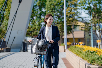 自転車で出勤するスーツを着た日本人女性