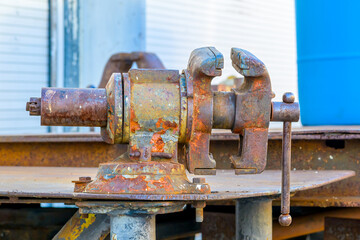A Rusted Iron Vice on an Outdoor Work Bench in New Orleans, LA, USA