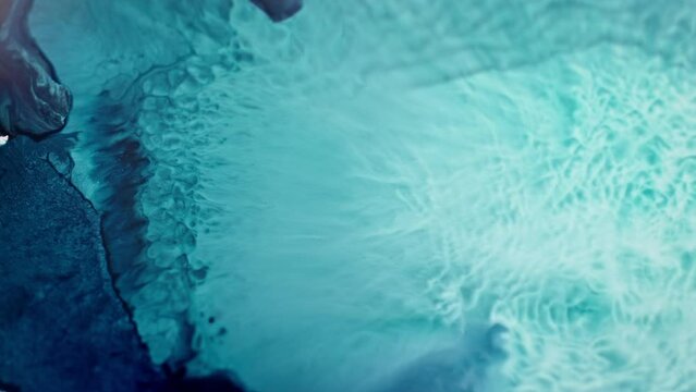 Crystal blue ink spreading in clear water creating an abstract pattern