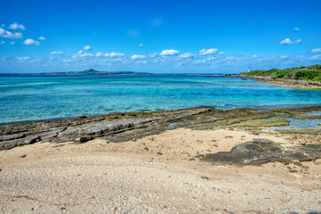 Crystal clear waters of Bise Beach, Motobu District, Okinawa main island. White sand beach with coral outcrops and small islands offshore