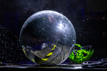 reflective ball on stage, protective helmet in the background
