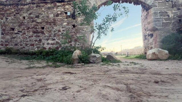 A revolving perspective of an ancient stone gate incorporated into the wall, embodying the essence of medieval architecture and temple design.