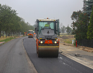 Vibratory asphalt rollers compactor compacting new asphalt pavement. Road service build a new highway

