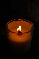 wax candle with flame in the dark, a candlelight in the dark