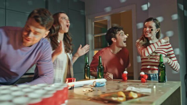 Woman throwing ball beer cups having failed. Friends playing alcohol ping pong