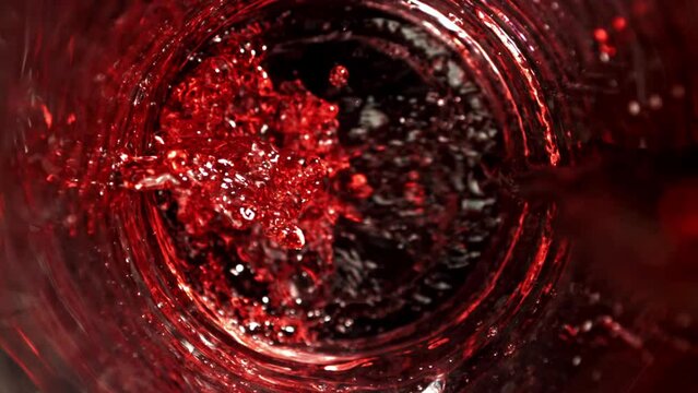 Red wine is poured into a glass. Top view. Filmed on a high-speed camera at 1000 fps. High quality FullHD footage