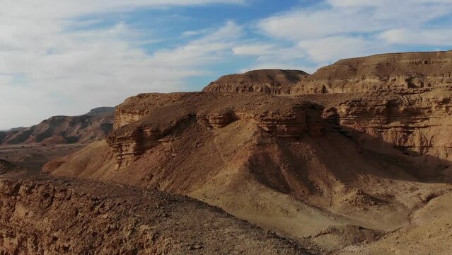 Arava Valley desert, Drone shot craine up move in front of desert hills and rocks, desert view all around