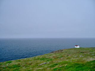 The edge of the land at the Cape Point Lighthouse area on a gray and misty day on the island of Newfoundland - 726860349