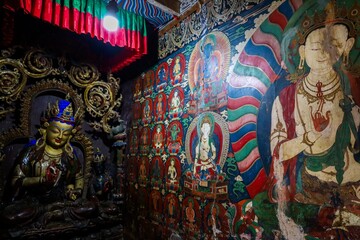 Explore the tranquil beauty of Kumbum Stupa's chapels, adorned with ancient Buddhist statues and vibrant Tibetan murals at Palcho Monastery in Gyantse, Tibet.