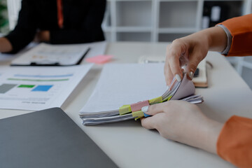 Businesswoman hands working in stacks of paper files for searching, business employee woman working...