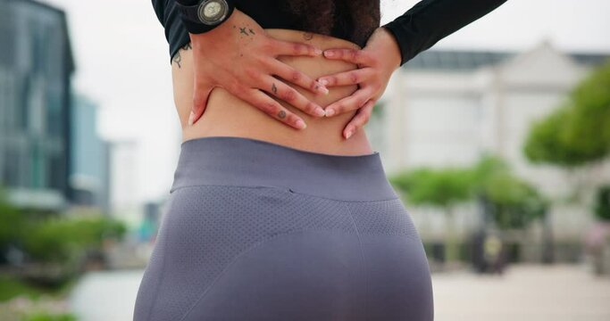 Back pain, fitness and hands of woman in city street with workout, mistake or anatomy emergency closeup. Backache, problem or female runner with sports burnout, fibromyalgia or arthritis from workout