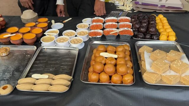 Cinematic shot of multiple Bengali sweets kept on table at Food Festival in Kolkata, India. No Face.