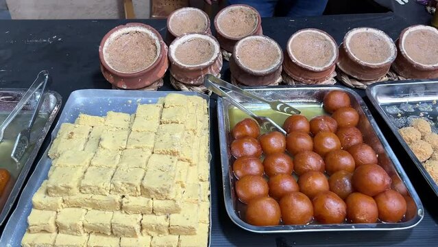 Closeup shot of Kalakand, Gulab jamun and Misti Doi kept in a sweet shop in Kolkata, India.