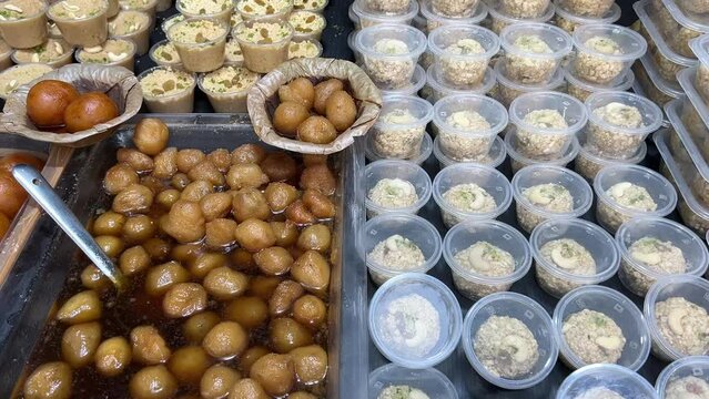 Profile view of Gur Rasgullas and other types of sweets. No Face.
