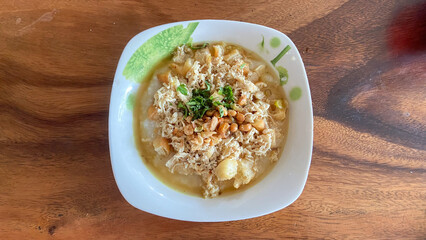 top view of rice porridge with pork and egg or congee is similar to boil rice but it has softer texture is on the wooden table for breakfast in the moring