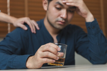 drunk man fall asleep on the table with whiskey glass