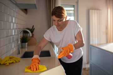 Young woman cleaning the kitchen