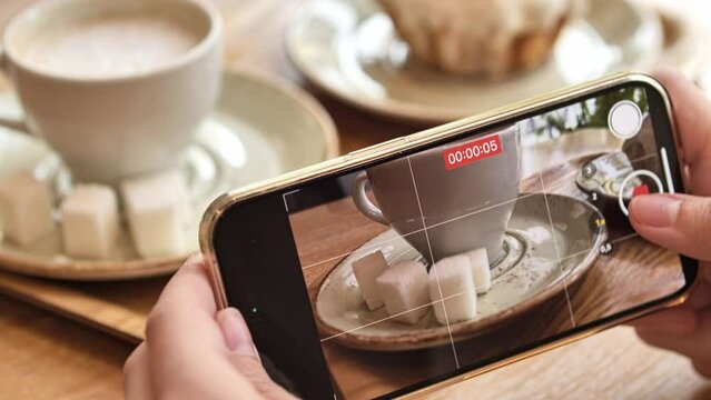 Close up of Woman Hands Taking Photos and Filming Videos Of Cup of Coffee and cubes of sugar with phone. Closeup. 4K. High quality 4k footage