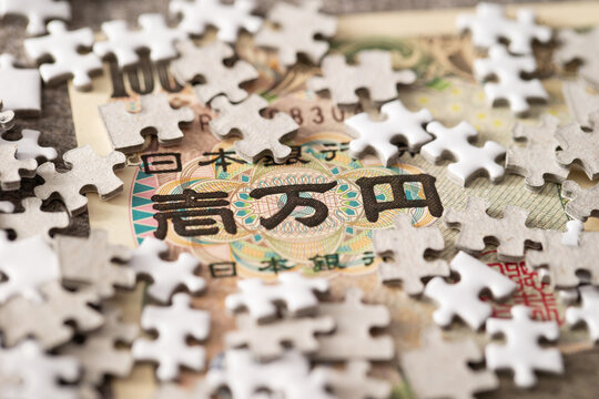 Japanese banknotes and jigsaw puzzle pieces