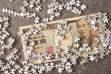 Japanese banknotes and jigsaw puzzle pieces