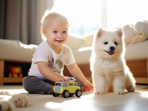 Smiling baby playing with a white fluffy puppy indoors.
