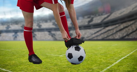 Obraz na płótnie Canvas Image of caucasian female soccer player over stadium