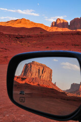 Sandstone buttes on a rear view mirror on the Scenic Drive of Monument Valley Navajo Tribal Park, Arizona, Southwest USA.