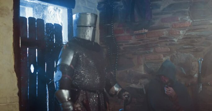 Frozen knight enters tavern from snowy street. Medieval warrior with sword and sack of loot visits merchant store. Dark ages lifestyle reconstruction