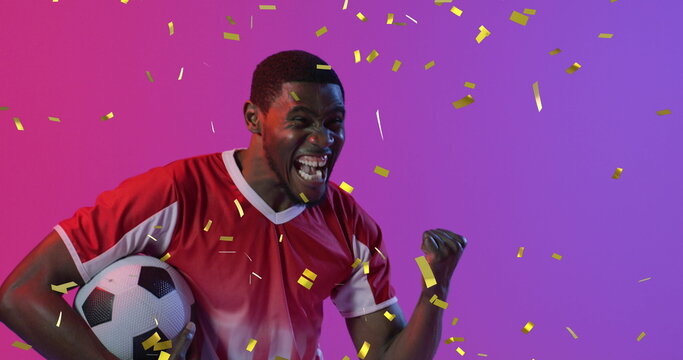 Image of african american male soccer player over confetti - Powered by Adobe