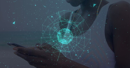 Globe of network of connections against african american woman using smartphone