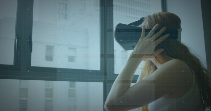 Image of scope scanning and data processing over woman wearing vr headset