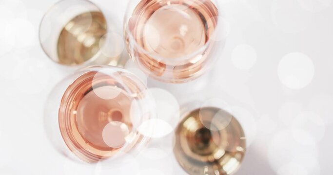 Composite of glasses of white, rose and red wine over white background