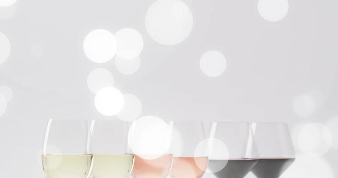 Composite of glasses of white, rose and red wine over white background