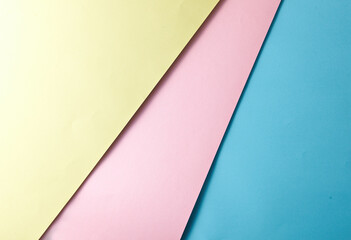Abstract background with triangular lines such as shape and blank space for creative design markers, intersection of blue and light pink and light yellow paper.