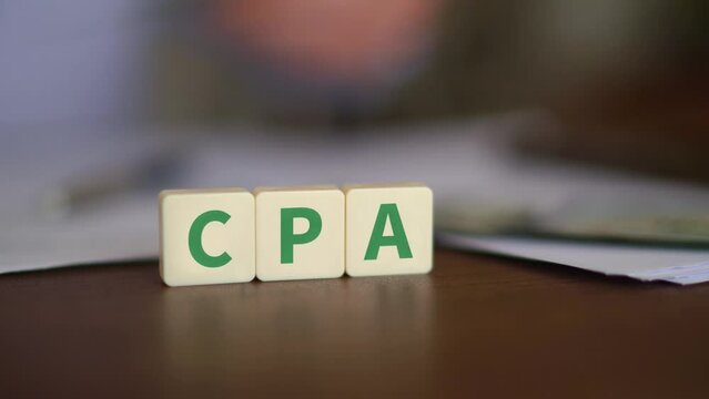 Concept of Cost Per Action advertising. CPA initials with selective focus and money on the background