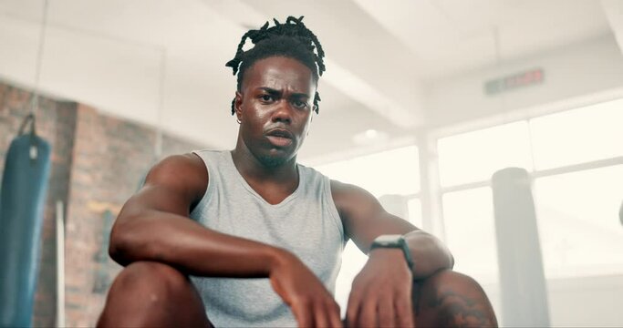 Fitness, sweating and face with black man in gym to rest from workout for health or cardio. Exercise, tired and breathing with exhausted young athlete training for performance or improvement