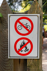 Warning sign banning bicycles and campfire