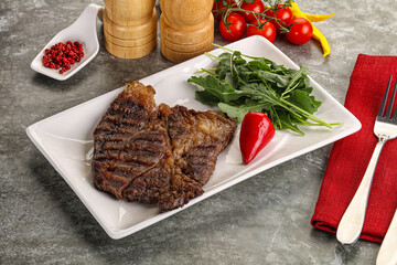 Grilled chuck roll steak with arugula