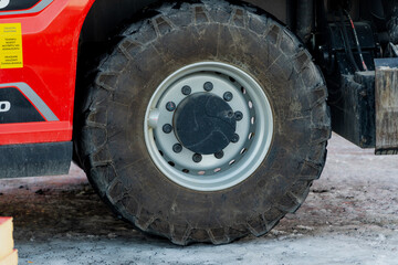 Heavy machinery construction truck big tyres in winter on construction yard