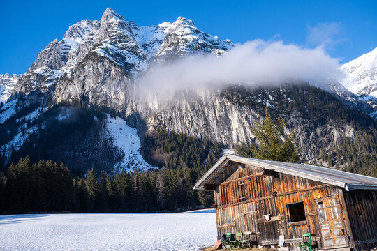 Wind-skewed wooden hut in front of Leutascher Drei-Torspitzen 2682m, Wetterstein Mountains, Austria in winter